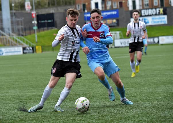 Institute's Jack McFeely battles for possession from Dergview right-back Aidan McCauley.  Picture: George Sweeney.