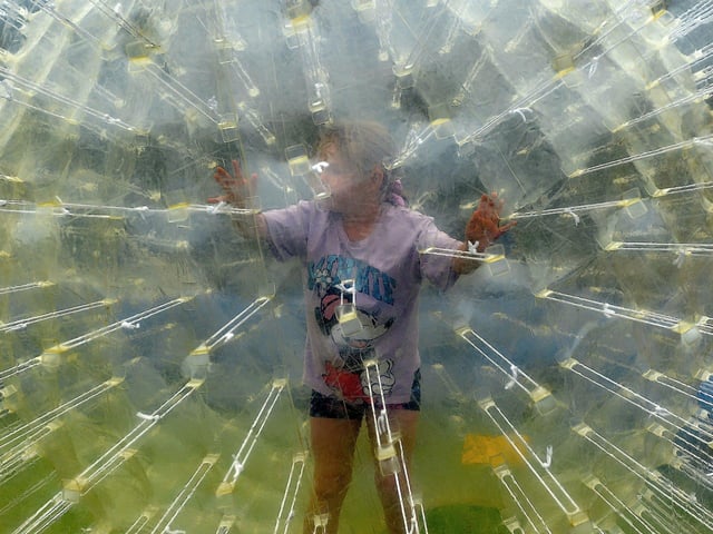 Enjoying the fun inside a bubble at the Pennyburn Youth Club fun day on Friday afternoon last. Photo: George Sweeney. DER2331GS – 94