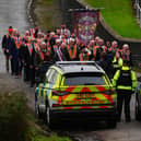 Orangemen make their way from Drumcree Church as police form a barricade to prevent them entering the Garvaghy Road.