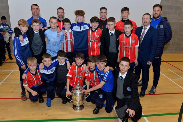 Derry City players Michael Duffy, Jordon McEneff and Liam Mullan pictured with St Columb's College Year 8 soccer players and PE staff during a visit to the school, with the FAI Cup, on Monday. Photo: George Sweeney. DER2247GS  22