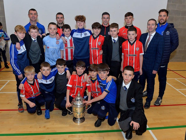 Derry City players Michael Duffy, Jordon McEneff and Liam Mullan pictured with St Columb's College Year 8 soccer players and PE staff during a visit to the school, with the FAI Cup, on Monday. Photo: George Sweeney. DER2247GS 22