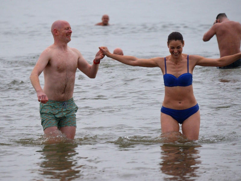 Swimmers brave the elements to take part in the annual Christmas morning charity swim at Ludden beach. Photo: George Sweeney. DER2252GS – 19