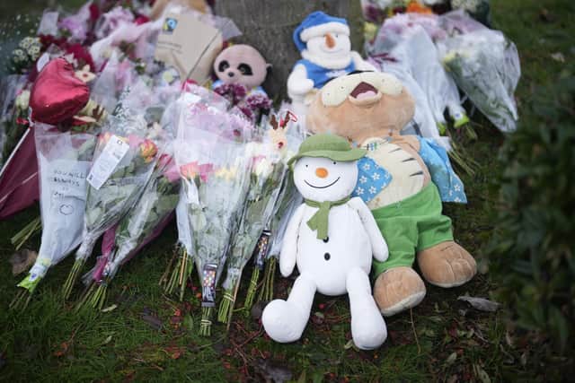 SOLIHULL, ENGLAND - DECEMBER 12: Flowers are left near the scene after three young boys died when a number of children fell through ice on a lake, on December 12, 2022 at Babbs Mill Park in Solihull, England. Three boys aged eight, 10 and 11 have died after falling through an icy lake last night. The search continued for more potential victims, following reports more children were present on the ice at the time of the incident. (Photo by Christopher Furlong/Getty Images)