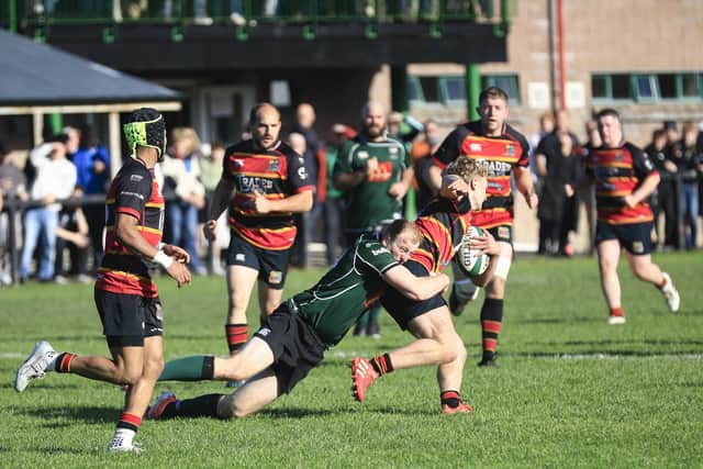 City of Derry’s Lewis Morton stops a Strabane player in the Championship 2 match at Judges Road. (Photo - Tom Heaney, nwpresspics)
