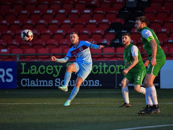 Institute’s Mikhail Kennedy crosses the ball into the Crumlin Star penalty area. Photo: George Sweeney