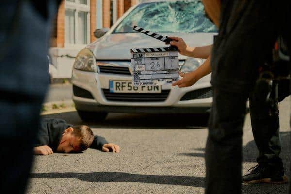 Actor Sonny Middleton, who plays Shawn O'Connor, lies in the street after being hit by a car.