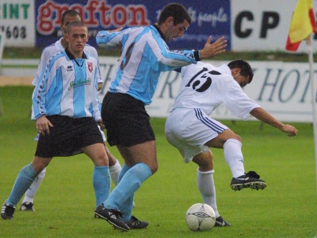 Stephen Parkhouse challenges a Real Madrid player.