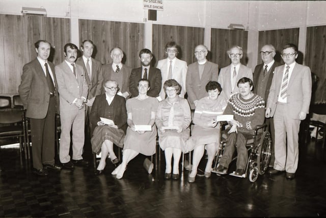 Molins presenting cheques to charity.