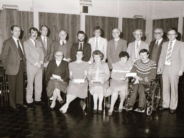 Molins presenting cheques to charity.