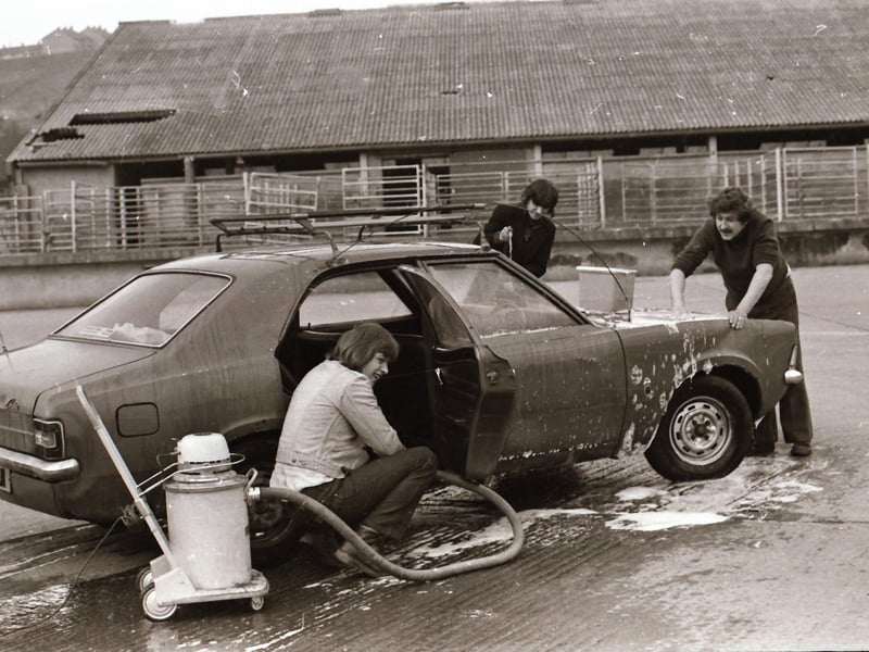 Two of the 15 young men from Long Tower Youth Club who were raising funds for the trip with one of the youth leaders by washing and valeting cars for 50p a go to help pay for their trip.