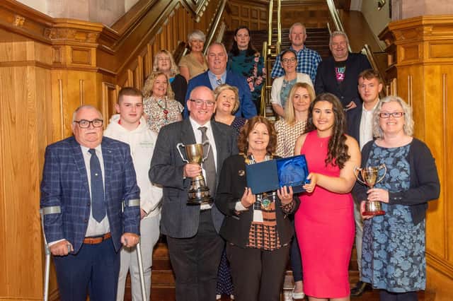 The Mayor Councillor Patricia hosted a reception for Róise ni Mhurchú, pictured with her dad Marcas, who brought home two gold medals from the All Ireland Fleadh in Irish Singing and lilting, unaccompanied vocal music. Included are mum and dad Caitriona and Marcus, members of Comhaltas, Ollie GHreen from Studio 2, singing tutors and Padriag Delagey MLA. Picture Martin McKeown. 31.08.23