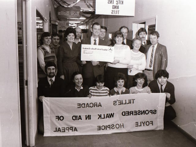 Tillie & Hendersons Arcade staff presenting a cheque to Dr Tom McGinley for the Foyle Hospice.