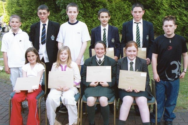 Some of the prizewinners in the Children In Crossfire writing competition were Front L/R:- Melissa Mullan, Natasha MCkenna, Bridget Mary Wilson and Roseanne Harley. Standing L/R:- Kevin Francis, Philip McLaughlin, Joseph McDermott, Kieran Fitzpatrick, Ryan McGurk and Noel McDonald. 260603HG3