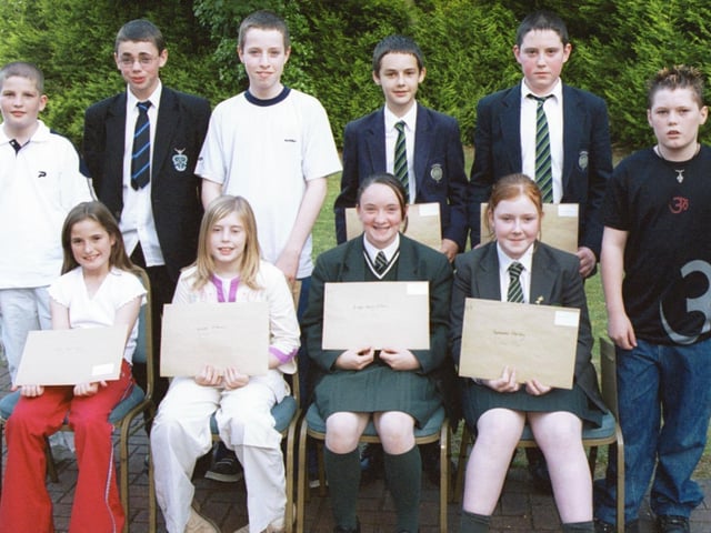 Some of the prizewinners in the Children In Crossfire writing competition were Front L/R:- Melissa Mullan, Natasha MCkenna, Bridget Mary Wilson and Roseanne Harley. Standing L/R:- Kevin Francis, Philip McLaughlin, Joseph McDermott, Kieran Fitzpatrick, Ryan McGurk and Noel McDonald. 260603HG3