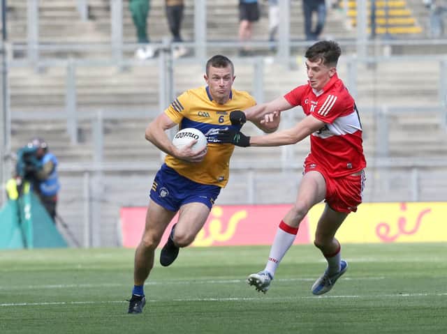 Derry's Paul Cassidy with Ciaran Russell of Clare during the All Ireland quarter final at Croke Park last June.