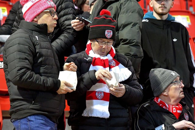 Fans enjoy some chips before Derry City’s game against Cork City on Friday evening. Photo: George Sweeney. DER2308GS – 138