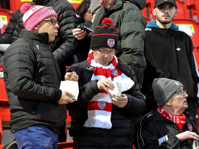 Fans enjoy some chips before Derry City’s game against Cork City on Friday evening. Photo: George Sweeney. DER2308GS – 138