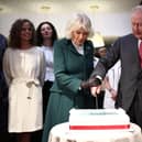 King Charles III and Queen Camilla cut into a cake during to Hunters Bakery in Limavady, on day two of the royal visit to Northern Ireland. Picture date: Thursday March 20, 2025. PA Photo. See PA story ROYAL King. Photo credit should read: Henry Nicholls/PA Wire