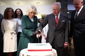King Charles III and Queen Camilla cut into a cake during to Hunters Bakery in Limavady, on day two of the royal visit to Northern Ireland. Picture date: Thursday March 20, 2025. PA Photo. See PA story ROYAL King. Photo credit should read: Henry Nicholls/PA Wire