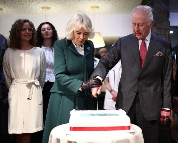 King Charles III and Queen Camilla cut into a cake during to Hunters Bakery in Limavady, on day two of the royal visit to Northern Ireland. Picture date: Thursday March 20, 2025. PA Photo. See PA story ROYAL King. Photo credit should read: Henry Nicholls/PA Wire