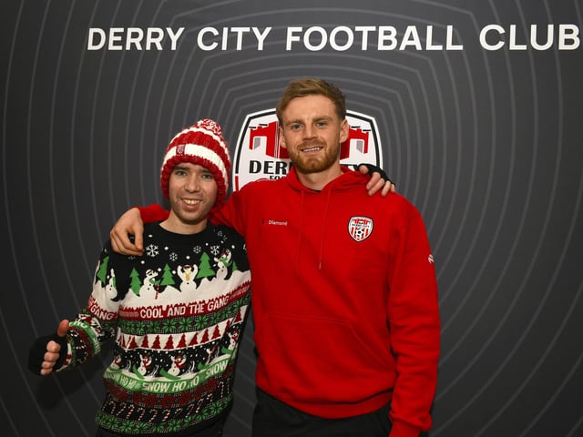Candystripe fan Donal Dunleavy pictured with Derry City's Rob Slevin at the club's merchandise outlet in Foyleside Shopping Centre. Photo: George Sweeney