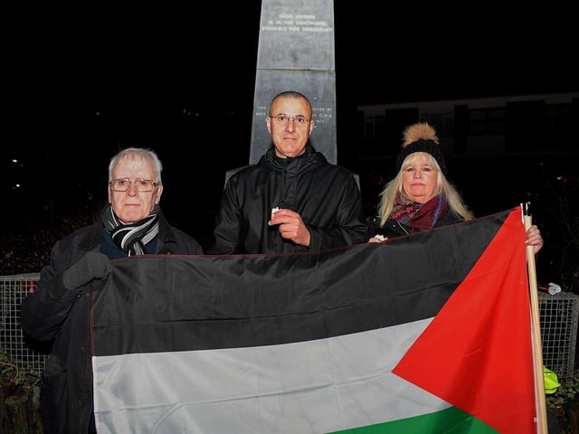 Omar Barghouti (centre), founding committee member of Palestine Campaign for the Academic and Cultural Boycott of Israel pictured with John Kelly and Maeve McLaughlin at a vigil for the children of Palestine held at the Bloody Sunday Monument on Rossville Street on Thursday evening. Photo: George Sweeney