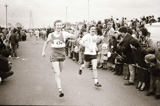 All smiles as this pair cross the finish line at the Male Mini Marathon in December 1983.