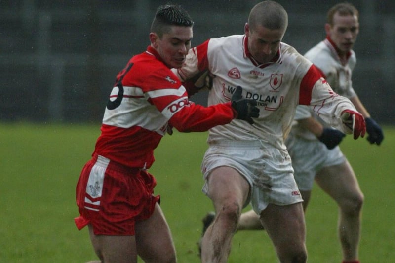 Derry's Ryan Lynch grapples with Tyrone forward Stephen O'Neill during the 2004 McKenna Cup meeting in Healy Park.