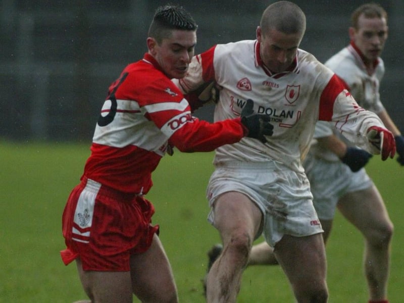 Derry's Ryan Lynch grapples with Tyrone forward Stephen O'Neill during the 2004 McKenna Cup meeting in Healy Park.