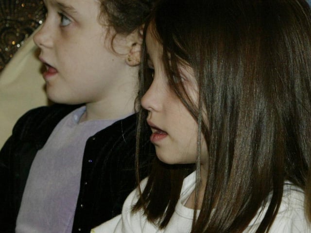 Childrens choir members singing during the carol srvice in St. mary's Church, Cregan for Children in Crossfire.  (1612JB92):Derry nativities and Christmas shows from December 2003