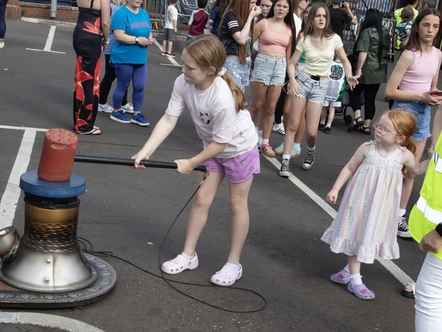 Young Nyle Moore showing off her strength at the Mega Fun Day in the Gasyard on Friday. (Photos: Jim McCafferty Photography) : .