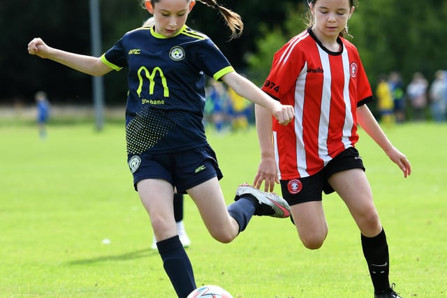 Sion Swifts defender Alanna Porter clears her lines under pressure from Tristar's Eabha O'Hagan during their Girls Under-11 match at Wilton Park.