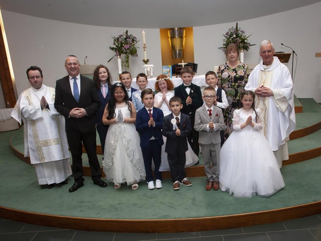 Children from Lisnagelvin Primary School who received the Sacrament of First Holy Communion from Fr. Michael Canny at the Sacred Heart Church, Trench Road on Saturday last. Included in photo are Deacon Sean Ward, Mr. Colin Torrens and teacher, Mrs. Taggart, Classroom Assistant. (Photo: Jim McCafferty Photography)