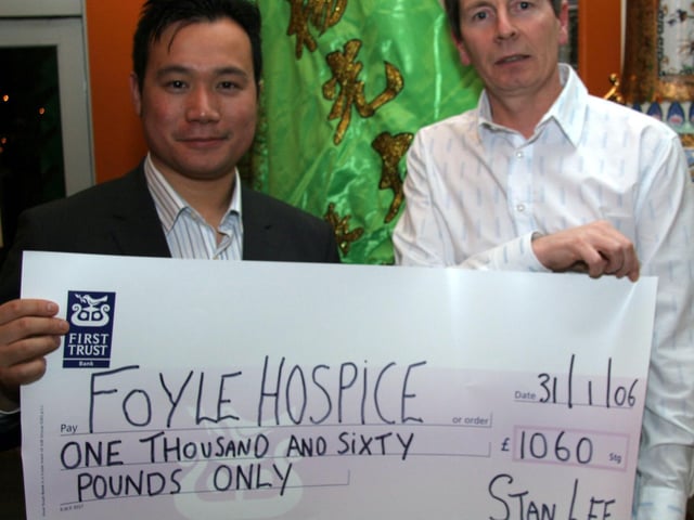 Paul McMonagle accepts a cheque from Stanley Lee, proprietor of the Mandarin Palace in aid of the Foyle Hospice, proceeds from the Chinese new year celebrations 0037JML