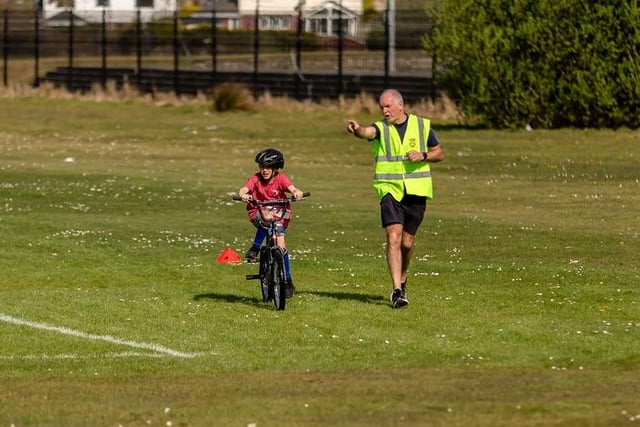 George Harkin helps out a young cyclist during the Caina Healey Children's Try-a-Tri at Templemore Sports Complex. (Photo: Michelle Camlbell)