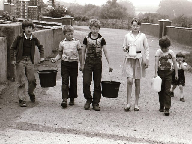 Children carrying pails of water back in 1984.