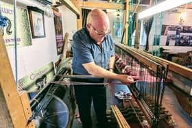 John Heena tying on the warp.