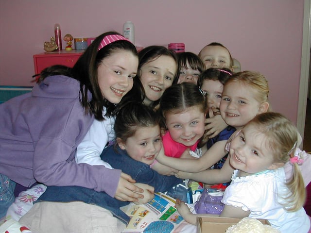 Birthday girl Niamh McDevitt being hugged by family and friends.