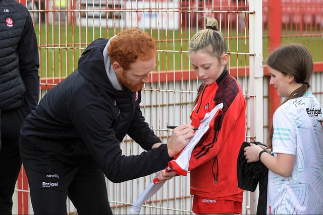 Conor Glass signs a shirt for a young fan before the Derry v Dublin game on Saturday. Photo: George Sweeney