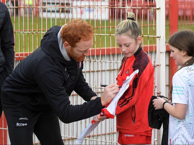 Conor Glass signs a shirt for a young fan before the Derry v Dublin game on Saturday. Photo: George Sweeney
