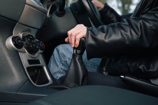 A driver changes gear.