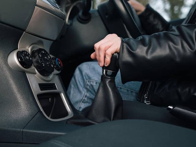 A driver changes gear.