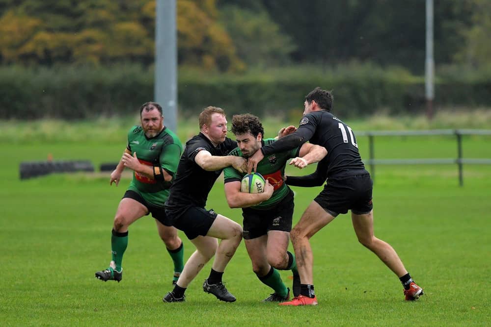 City of Derry’s Alex McDonnell is tackled by Connemara pair Ian Heanue and Shane Sweeney during last week's All Ireland Junior Cup tie. The out-half misses this weekend's trip to Carrick. Photo: George Sweeney