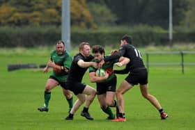 City of Derry’s Alex McDonnell is tackled by Connemara pair Ian Heanue and Shane Sweeney during last week's All Ireland Junior Cup tie. The out-half misses this weekend's trip to Carrick. Photo: George Sweeney