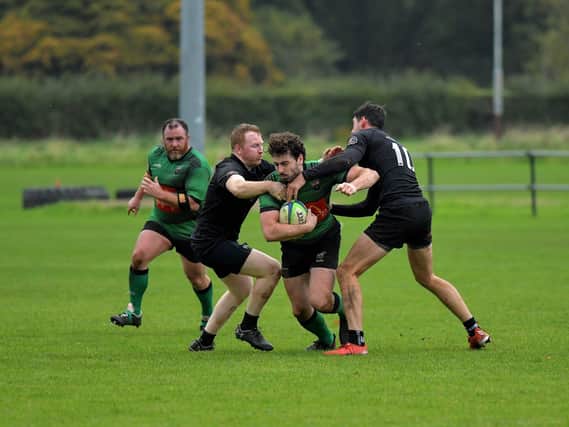 City of Derry’s Alex McDonnell is tackled by Connemara pair Ian Heanue and Shane Sweeney during last week's All Ireland Junior Cup tie. The out-half misses this weekend's trip to Carrick. Photo: George Sweeney
