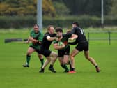 City of Derry’s Alex McDonnell is tackled by Connemara pair Ian Heanue and Shane Sweeney during last week's All Ireland Junior Cup tie. The out-half misses this weekend's trip to Carrick. Photo: George Sweeney