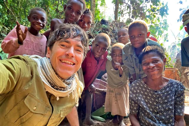 Simon Reeve with a remote Baka community in the Congo