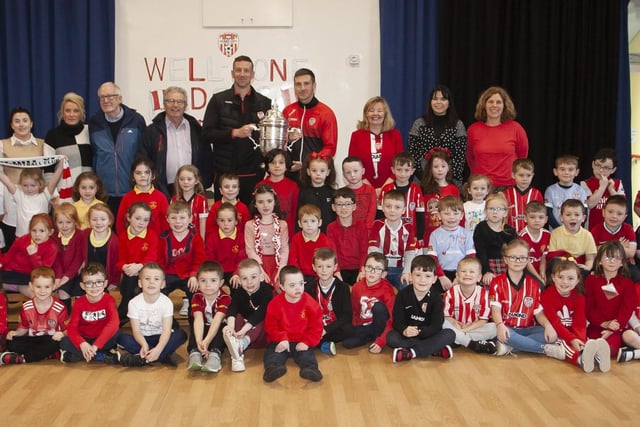 Steelstown Primary School Primary 2 pupils pictured with Shane and Patrick McEleney, the FAI Cup and staff, past and present. (Photo: Jim McCafferty)
