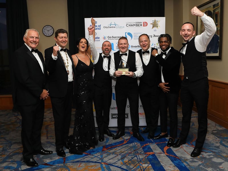Ian Crowe and Greg McCann celebrating with The Cosh Bar & Grill team, winners of Pub of The Year.