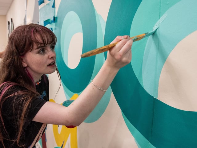 Art and design student Ciara Darcy gets to work painting the new mural at Strand Road campus during NWRC's Freshers' fest. 